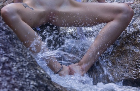 Beautiful teen Alisa M shows her naked body with her feet in the water