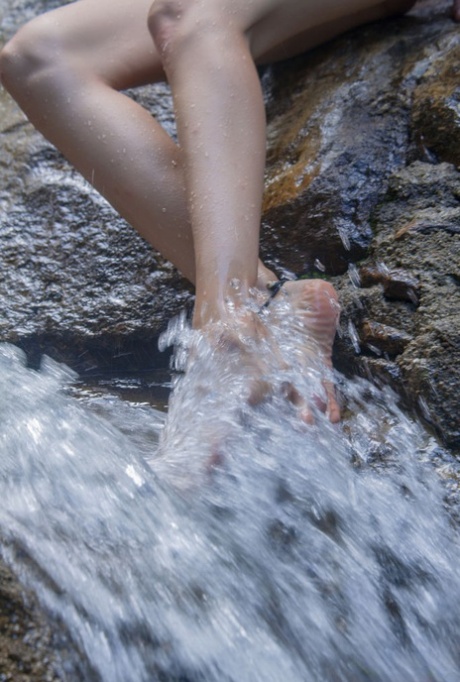 Beautiful teen Alisa M shows her naked body with her feet in the water