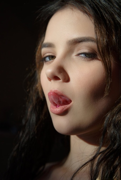 Beautiful brunette teen Chanel Fenn licks her lips after showing her hard body