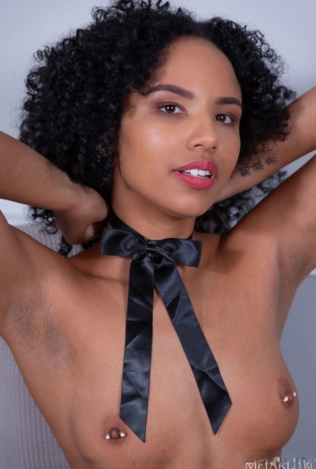 Ebony teen Romy Indy reveals her pierced nipples while going bare naked