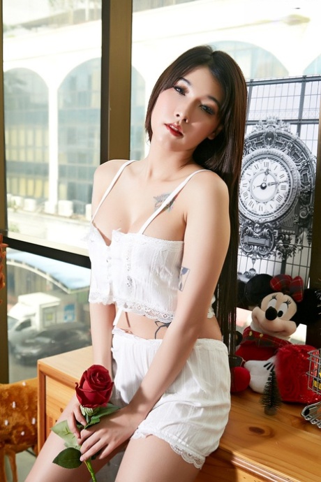 Beautiful Asian girl Poppy slips a dildo inside her trimmed pussy