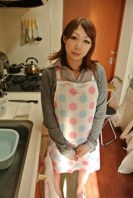 Japanese housewife Eri Fujino shows her tits and ass in an apron