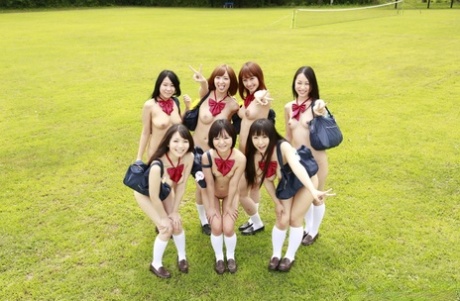 A group of Japanese girls pose nude in a field in white socks