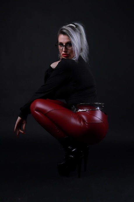 Platinum blonde Avengelique models in glasses while wearing latex pants