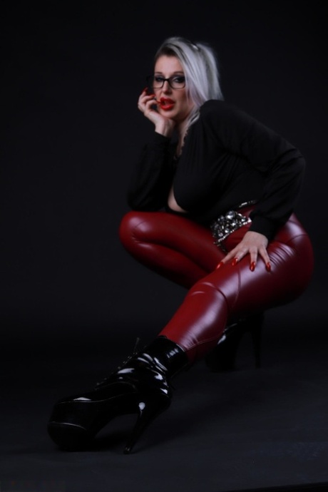 Platinum blonde Avengelique models in glasses while wearing latex pants