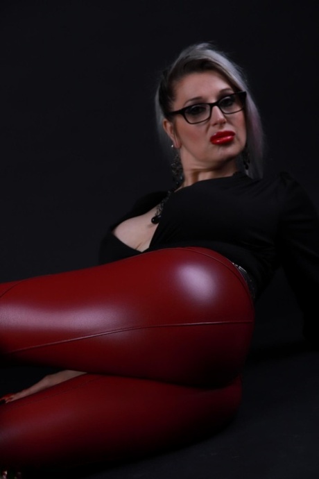 Platinum blonde Avengelique models in glasses while wearing latex pants