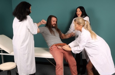 British women in lab coats subdue a patient with a bout of CFNM sex