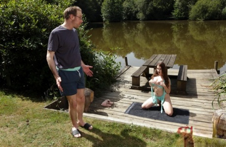 British chick Brook Logan gets naked on a dock while watching a man jack off