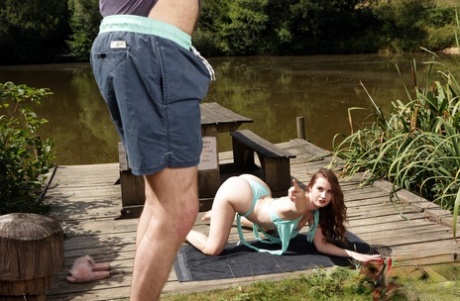 British chick Brook Logan gets naked on a dock while watching a man jack off