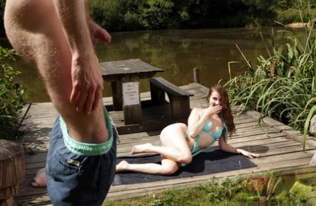 British chick Brook Logan goes nude on a dock while watching a man jerk off