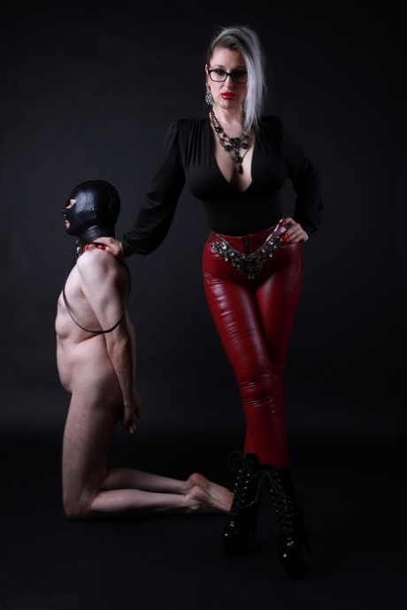 Platinum blonde Avengelique forces a naked male slave to the ground