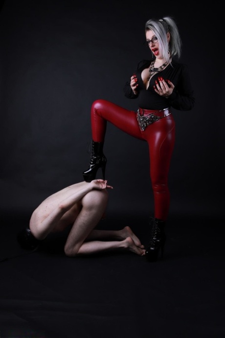 Platinum blonde Avengelique forces a naked male slave to the ground