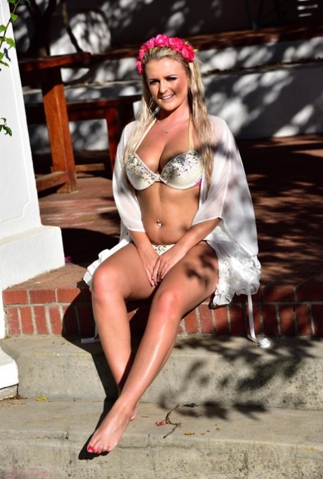 British teen Lycia Sharyl gets totally naked near rose bushes on a patio