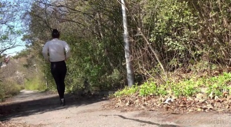 White girl Lara Fox pulls down black leggings while pissing on a country road