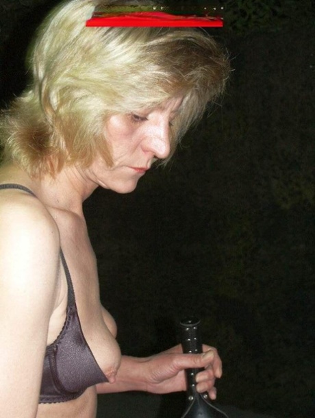 Blonde woman Uschi Haller tops a male slave in her bra and thong