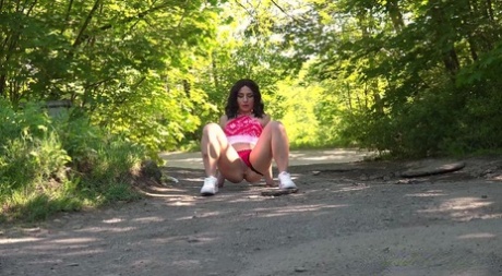 Brunette chick Lola takes a piss while out for a walk in the countryside