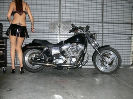 Blonde solo girl Aussie Jewel poses on a Harley before getting naked