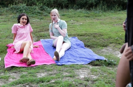 British girls give a CFNM handjob in a clearing near the woods