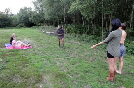 British girls give a CFNM handjob in a clearing near the woods