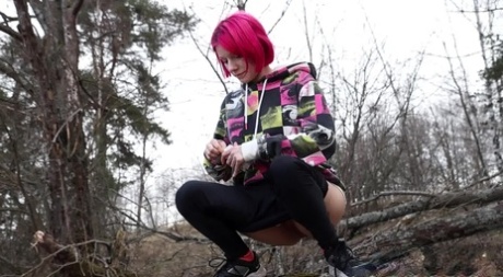 Solo girl with pink hair Vasya takes a badly needed pee over a boulder