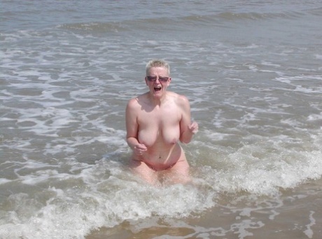 Blonde lady Tiffany Pearl goes nude in shades while at the beach