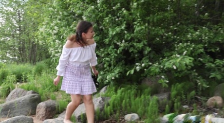 Nice girl Summy May takes a badly needed piss atop a boulder at the beach