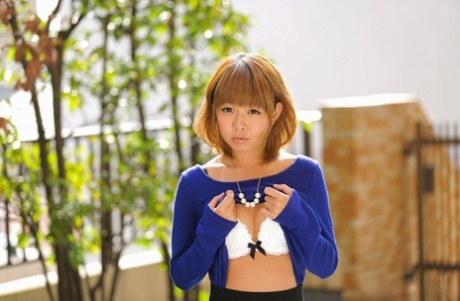 Adorable Japanese girl Fu Sazanami exposes her tiny tits while outdoors