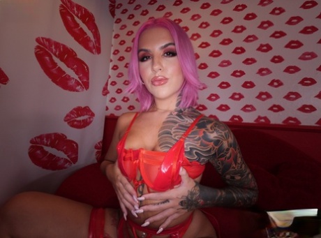 Tattooed chick with pink hair Luna Legend attends to the ball sac during a BJ