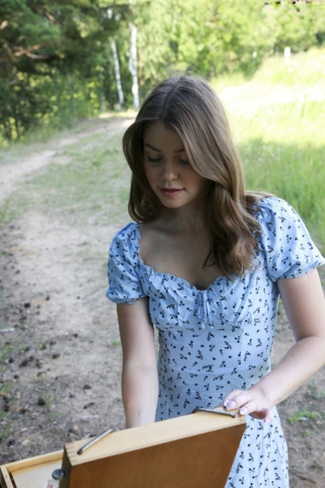 Nice teen Juny makes her nude modelling debut near some softwood trees