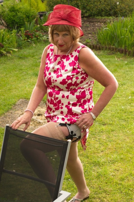 Horny mature British woman in stockings masturbating in the garden
