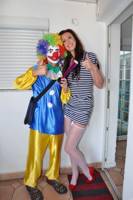 Tall female Lara Latex gets on top of a clown's big cock while having sex
