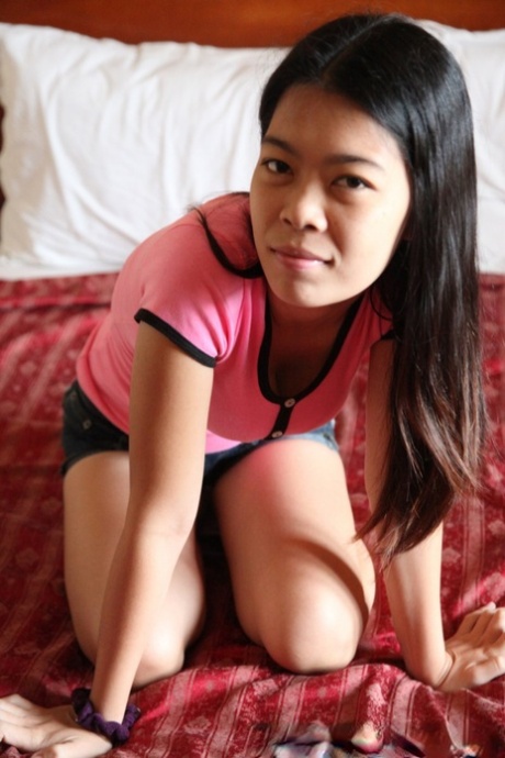 Filipina girl Marie stands naked after removing her clothes for the first time