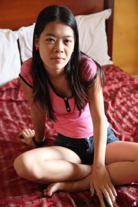 Filipina girl Marie stands naked after removing her clothes for the first time