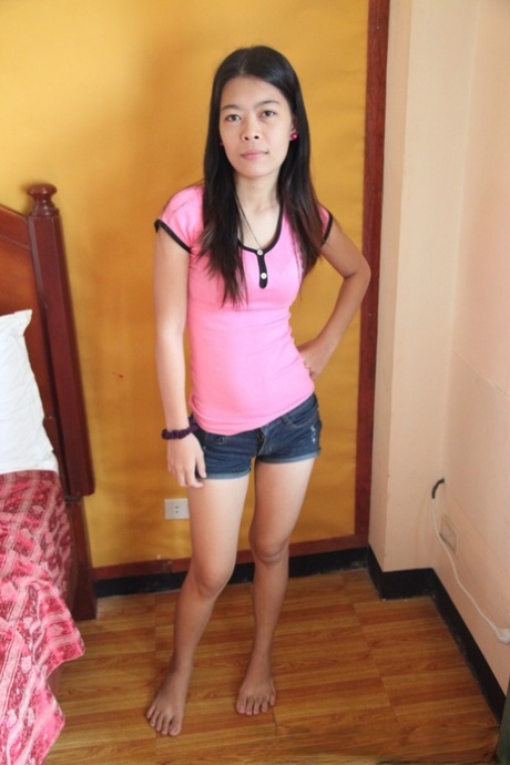 Filipina girl Marie stands naked after removing her clothes for the first time