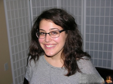 Nerdy girl takes a cumshot on her bare ass after getting naked to jerk a dick