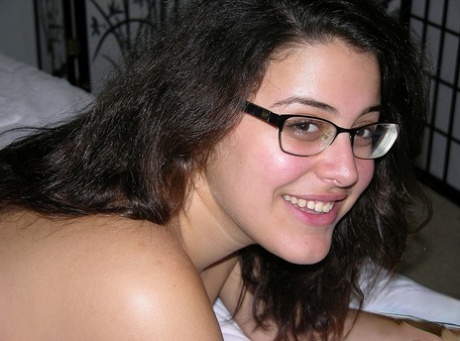Nerdy girl takes a cumshot on her bare ass after getting naked to jerk a dick