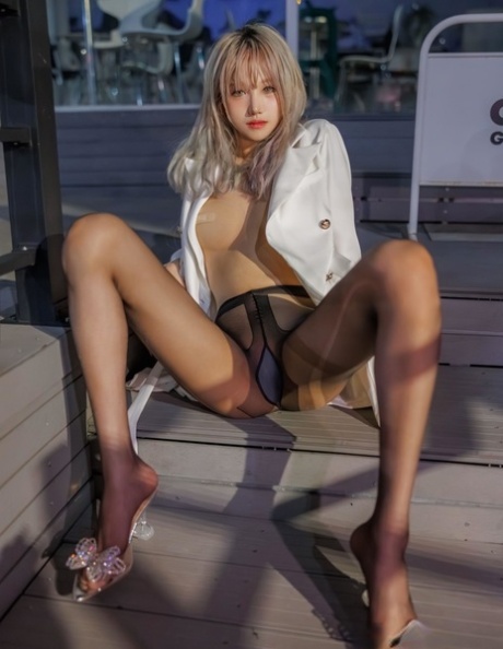 Petite Asian babe shows off her small tits while teasing in pantyhose