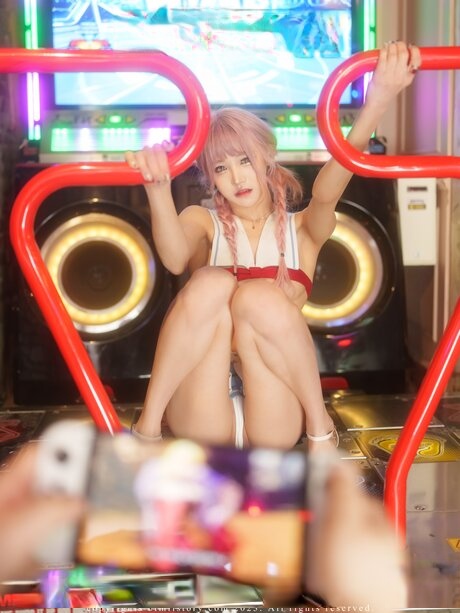 Sexy South Korean girl teases while up on a stage in skimpy clothing