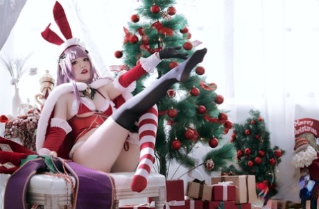 Purple haired Asian babe teases with her amazing curves in a Xmas outfit