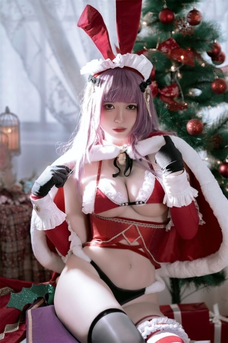 Purple haired Asian babe teases with her amazing curves in a Xmas outfit