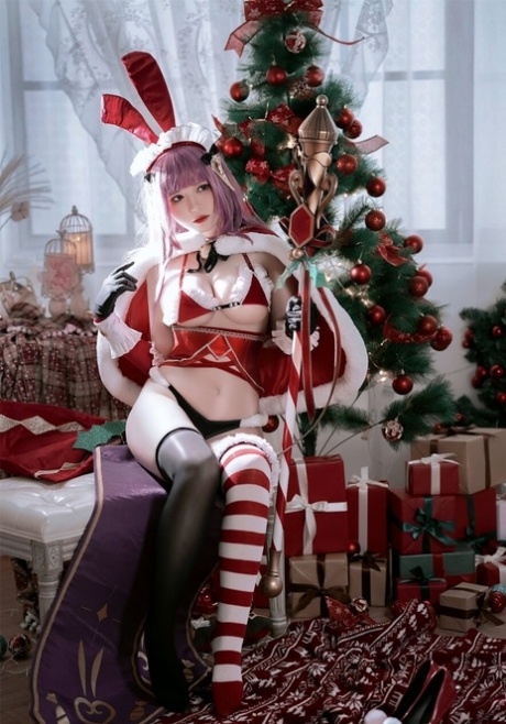 Purple haired Asian babe teases with her amazing curves in a Xmas outfit