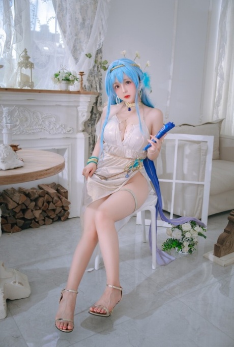 Pretty Asian babe shows her big ass while teasing in a sexy dress