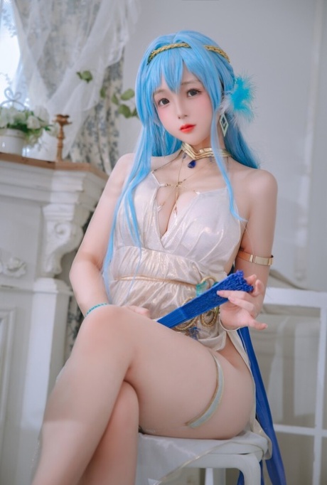 Pretty Asian babe shows her big ass while teasing in a sexy dress