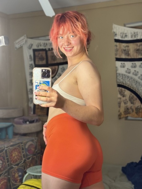 Amateur girl with a nose piercing Redhead Abby takes selfies in spandex shorts