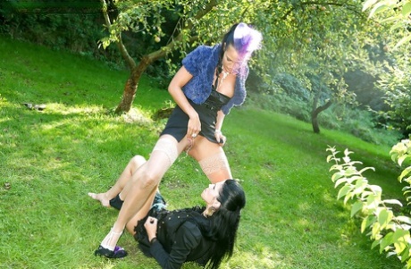 Partly clothed fetish vixens have some pissing and pussy toying fun outdoor