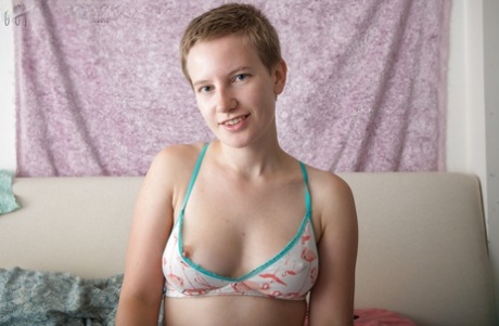Short haired teen Zina strips off athletic clothes for nude posing