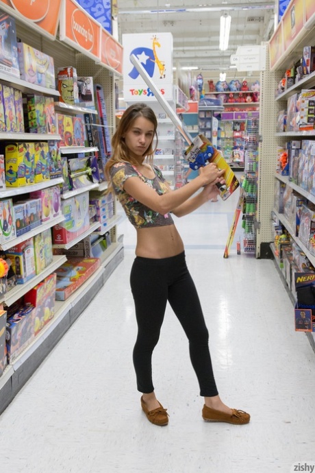 Teen girlfriend Uma Jolie flashing her titties and her ass in a toy store - pornpics.de