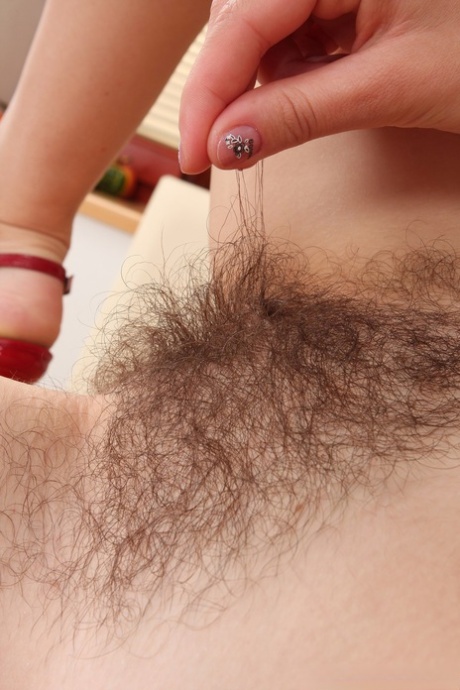 Cute amateur Nessy reveals her hairy pussy and rubs it up close - pornpics.de