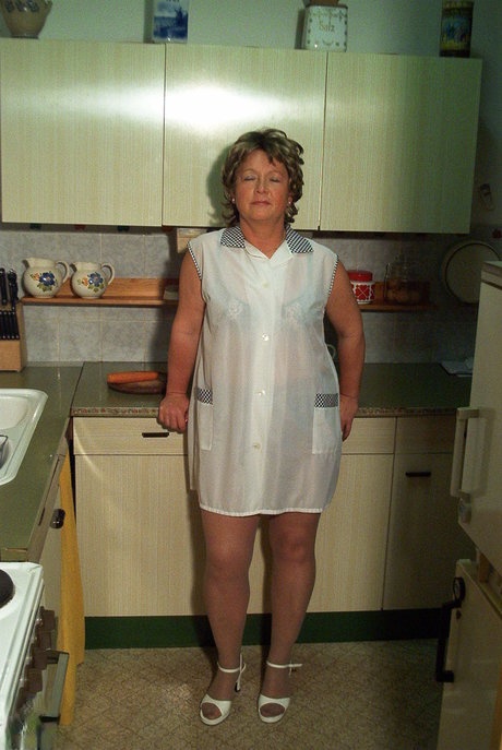 Petite granny Rita removes her dress and nylons and masturbates in the kitchen