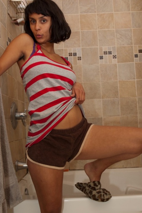 Skinny babe with big tits Sonya N shows her hairy crotch in a bathtub